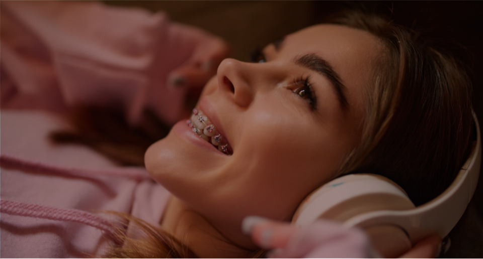 girl with braces listening to music